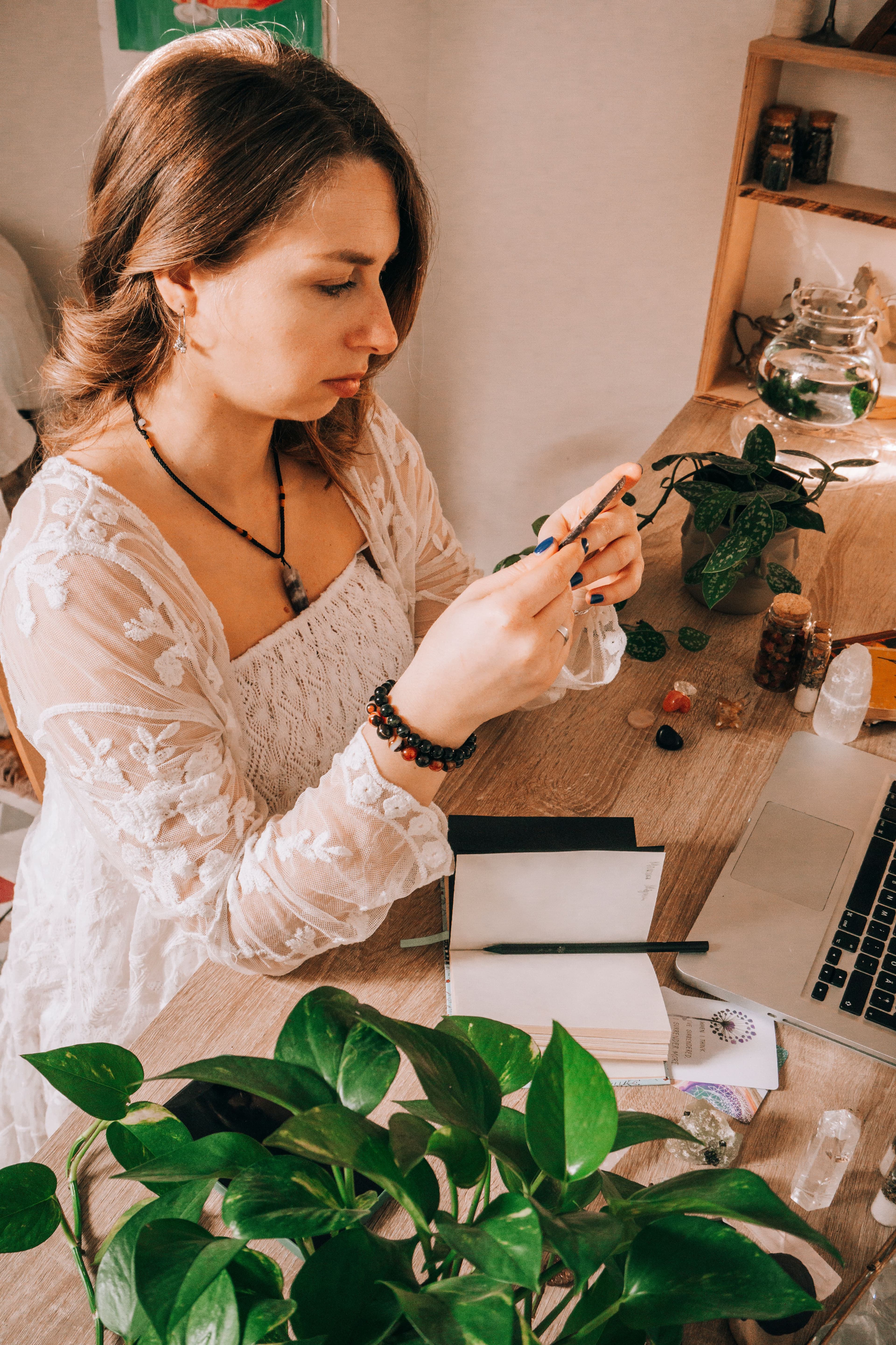 A tarot reader writing notes beside her cards